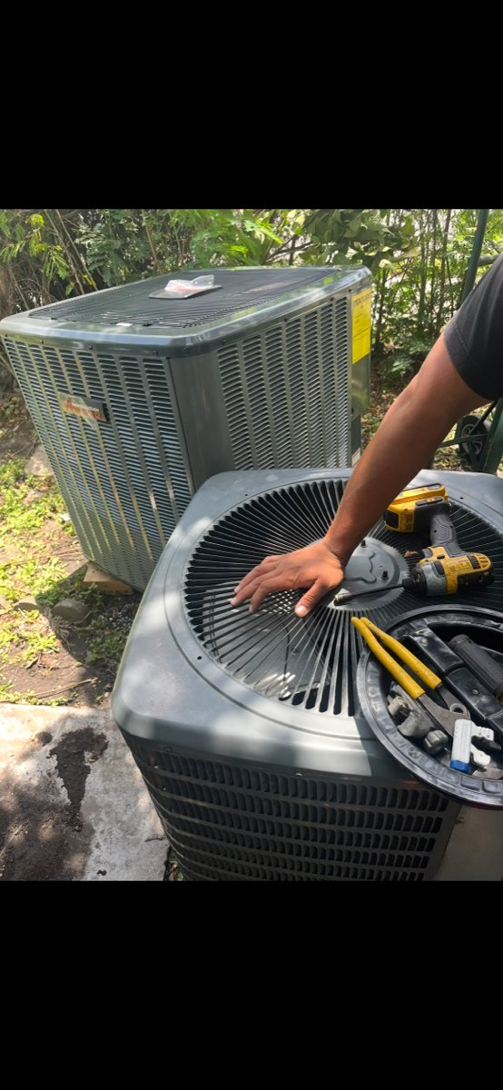 Outdoor air conditioning condenser unit being repaired